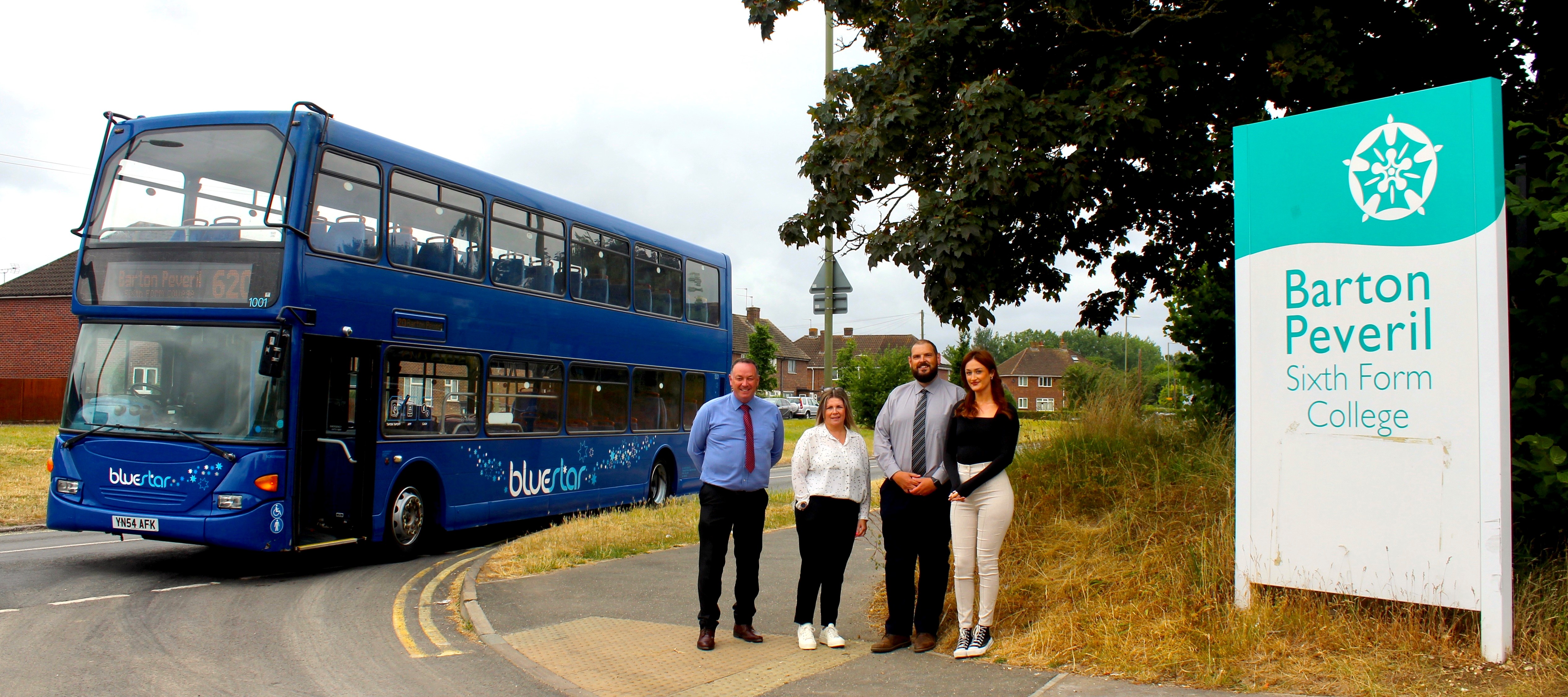 Representatives from Bluestar outside Barton Peveril College with staff and a bus image