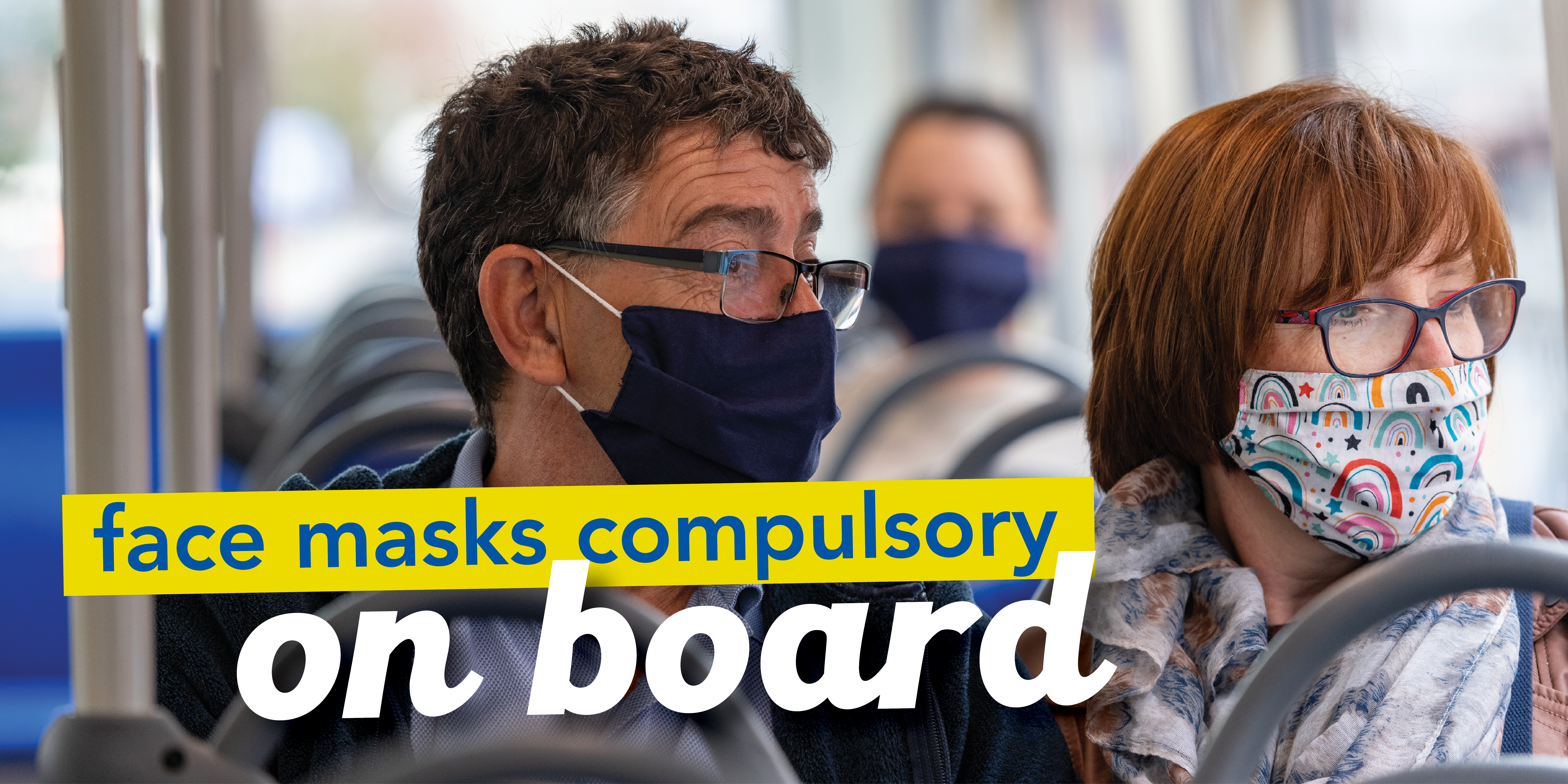 image of two people on a bus wearing face masks