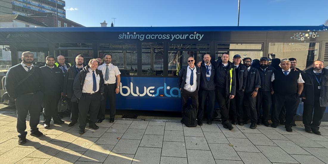 Men gathered outside a Bluestar bus