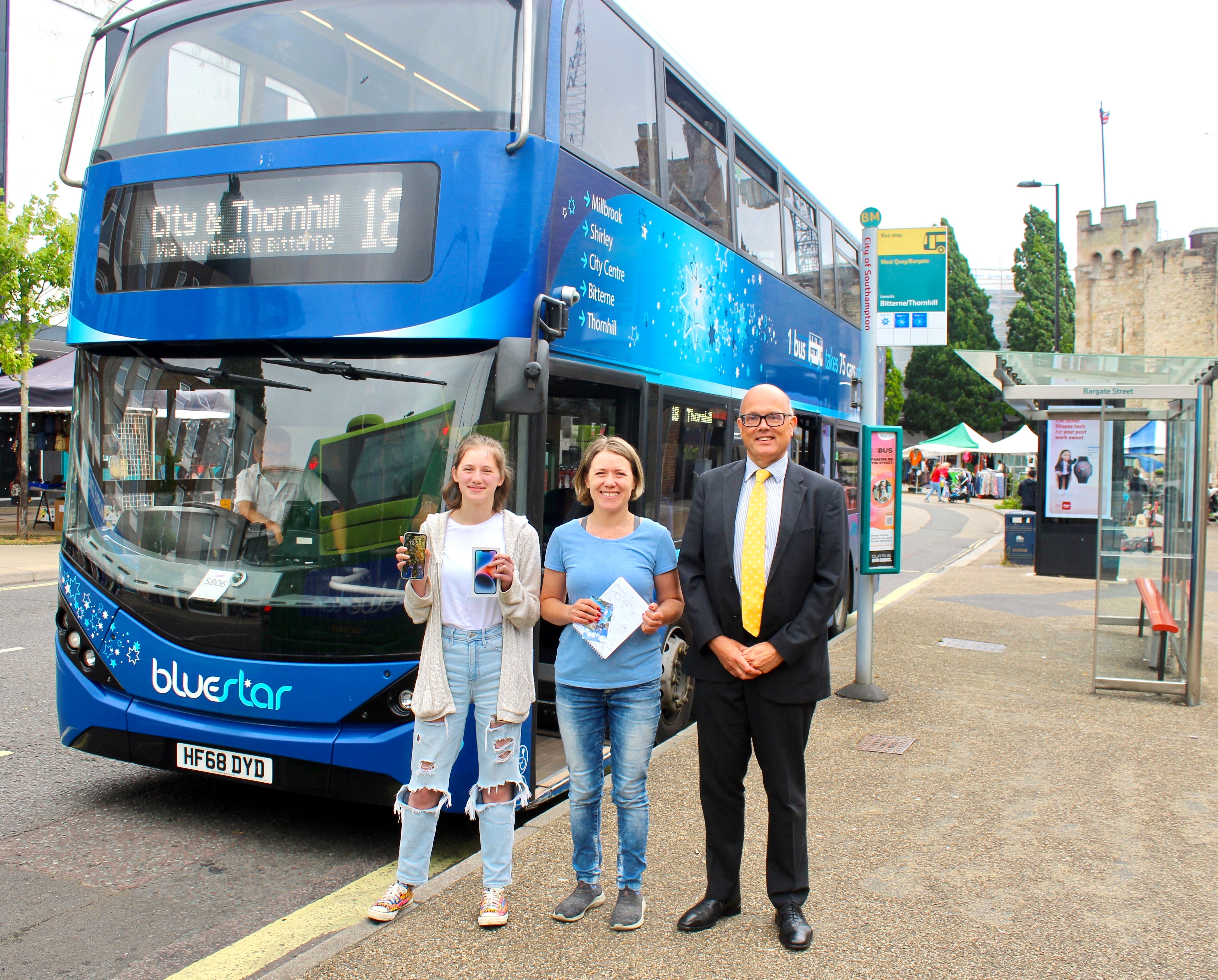 £2 fare video winners and Bluestar managing director in front of bus image