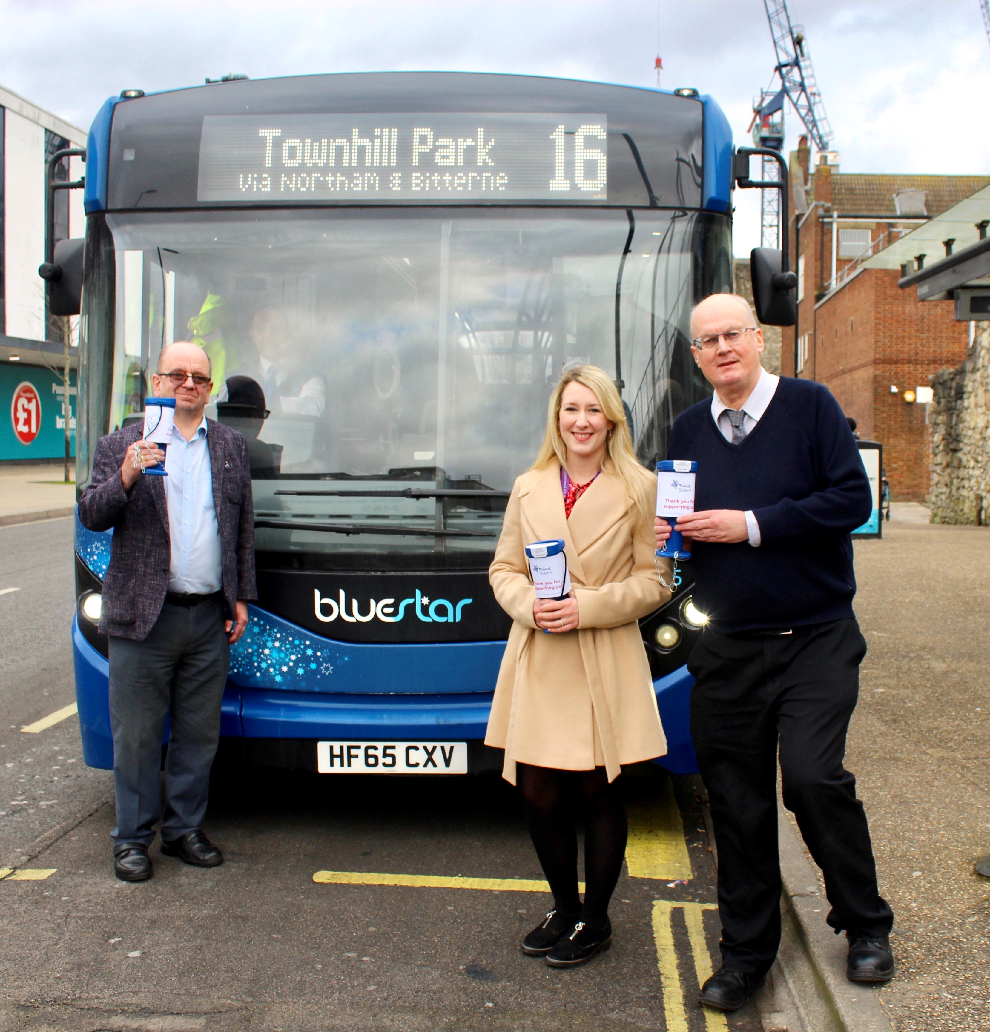 Bluestar representatives in front of a Bluestar bus with a lady from Solent Mind
