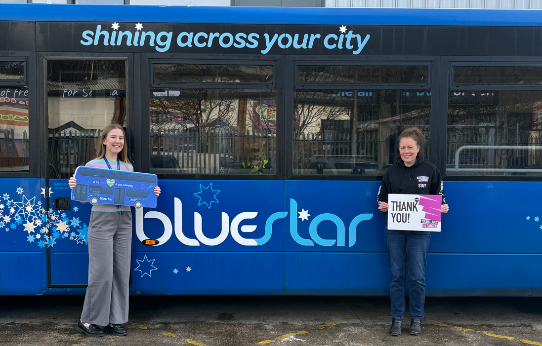 two women stood next to a Bluestar bus