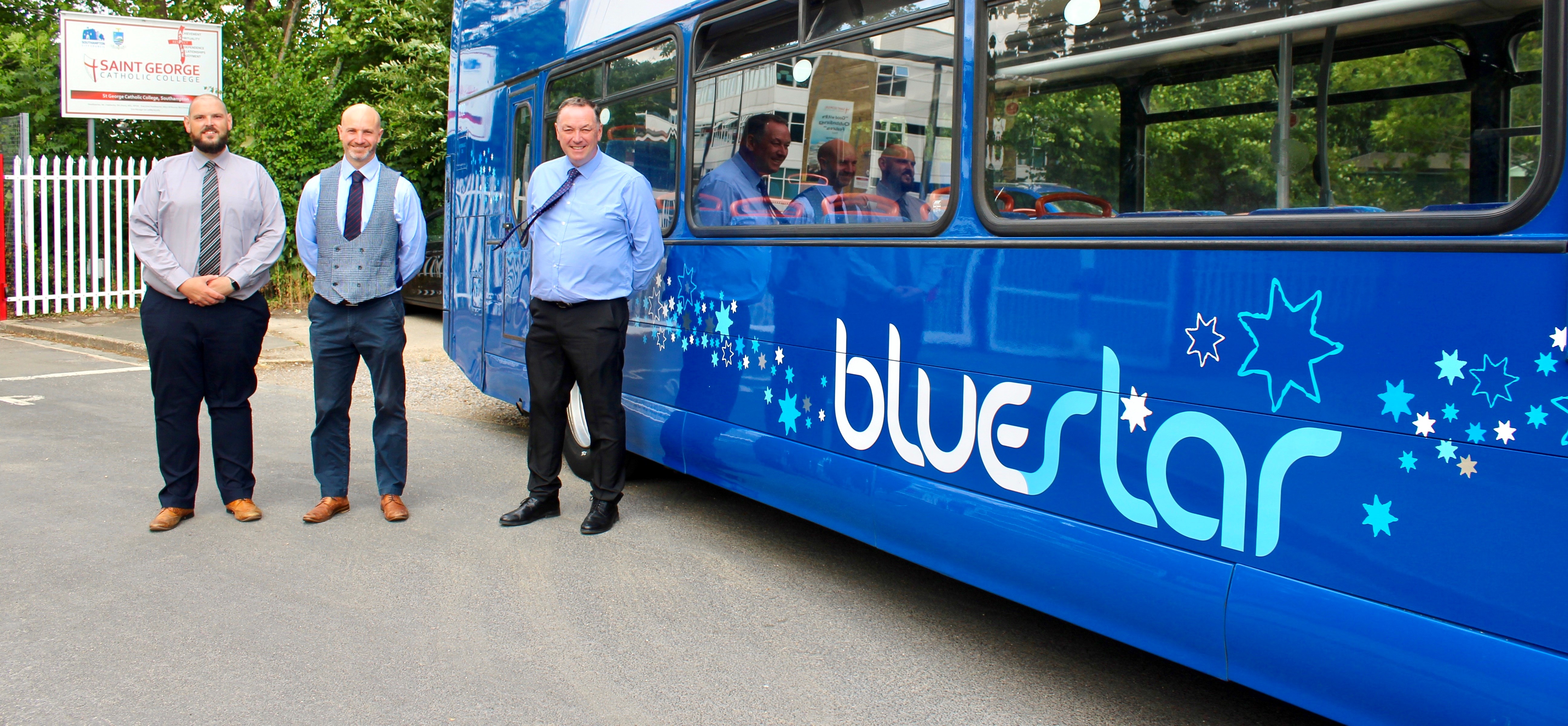 Representatives from Bluestar outside St George College with staff member and bus image